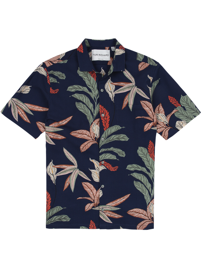 Navy tropical leaf-print short-sleeve shirt with red, green, and cream accents, front view.