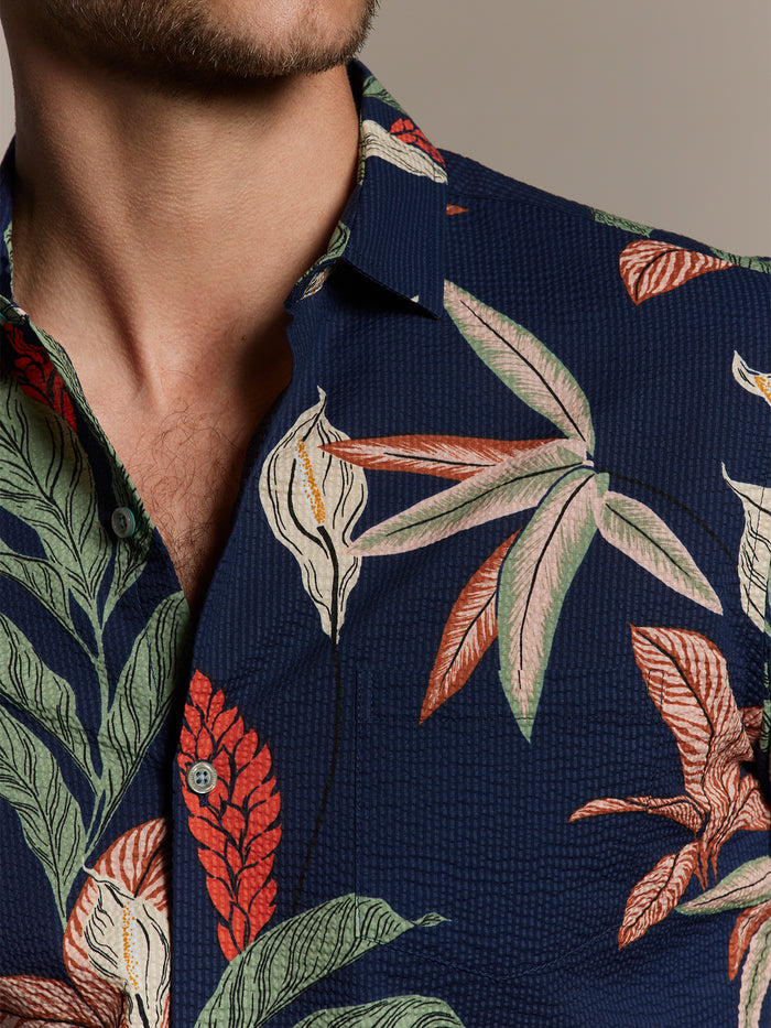 Navy floral-print cotton shirt with open collar, shown on man, front view (Image 1 & 2).