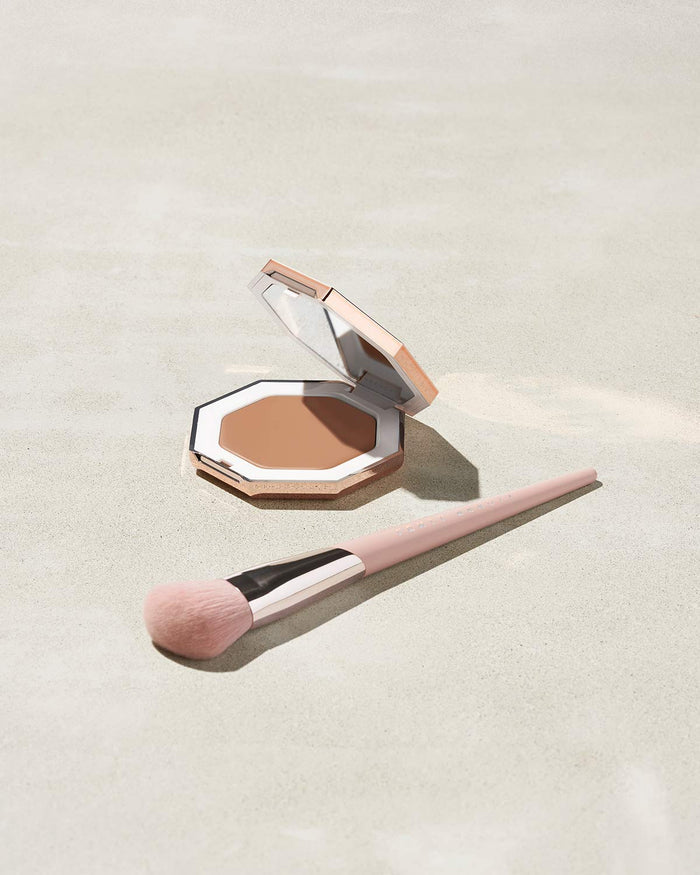 Cheeks Out Freestyle Cream Bronzer shown in shade Butta Biscuit with Face Shaping Brush 125