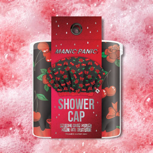 Manic Panic waterproof shower cap packaging featuring red cherry and bow print on a black background against a red bubble backdrop