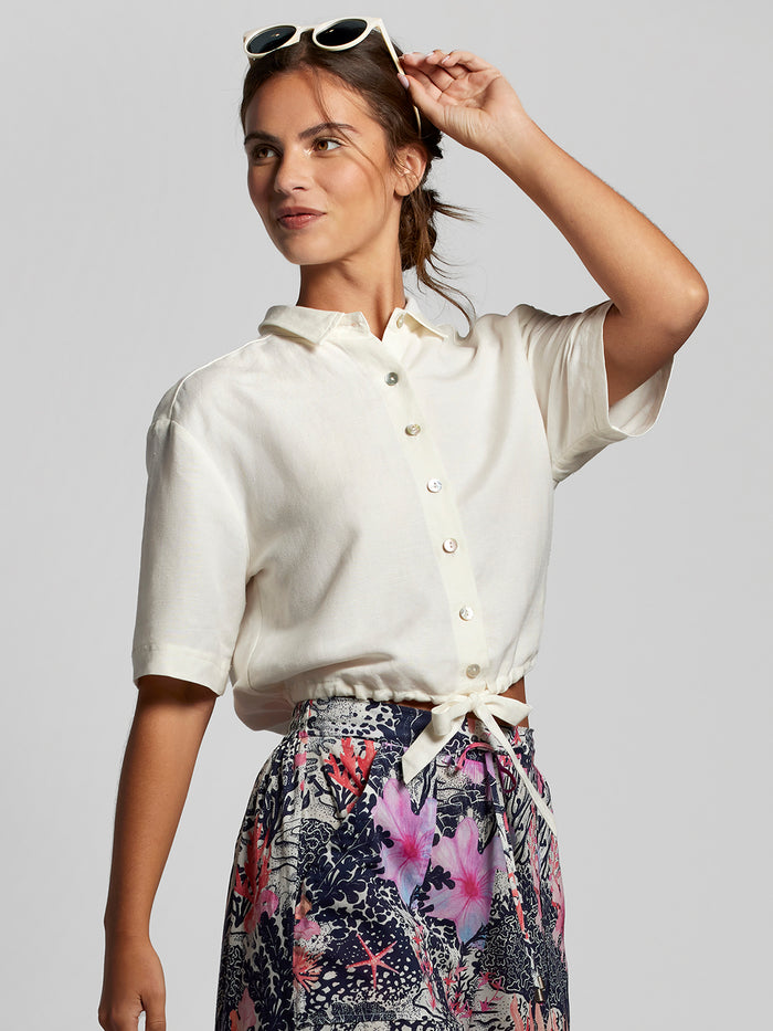 White blouse and multicolored floral-print skirt, front view.