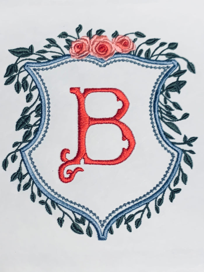 CREST WITH GREENERY AND FLORAL TOP