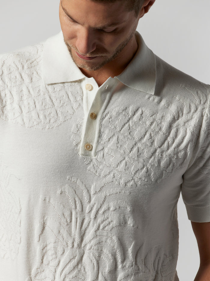 Textured white short-sleeve cotton collared shirt with three buttons, front view.