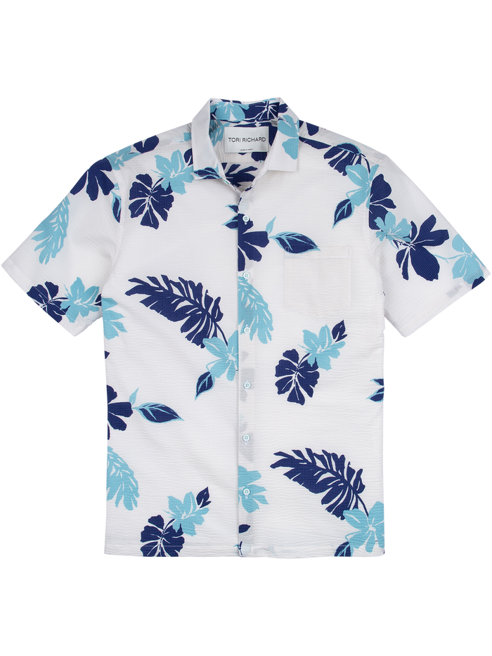 White and blue tropical-print short-sleeve shirt with chest pocket, flat lay front view.