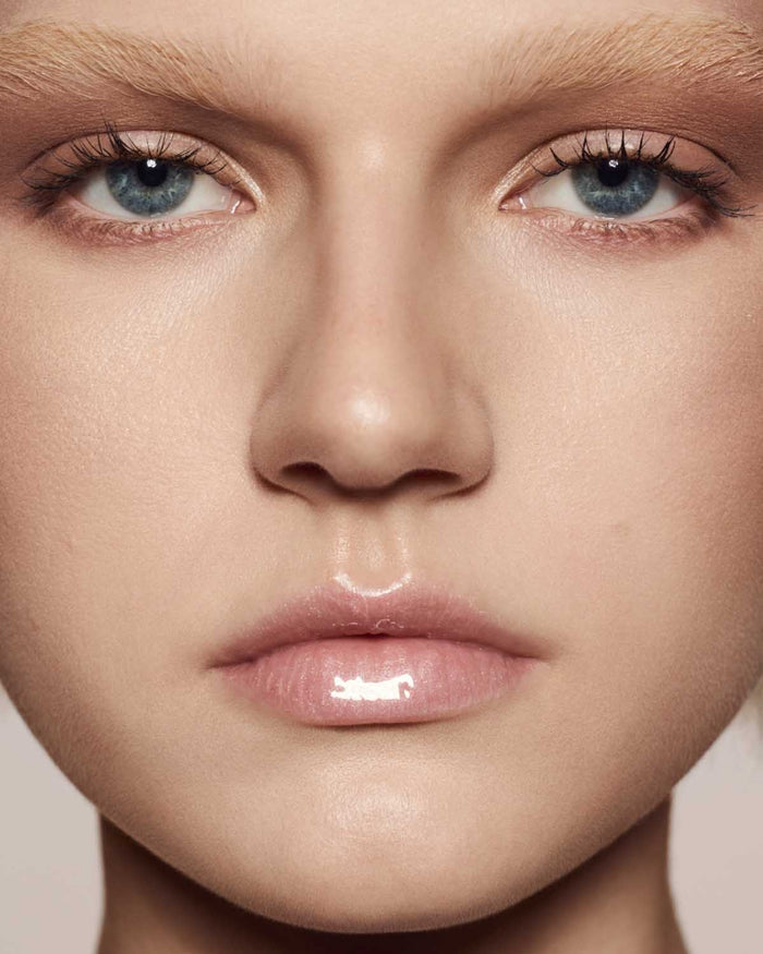 light skin toned model wearing gloss bomb universal lip luminizer in $weetmouth