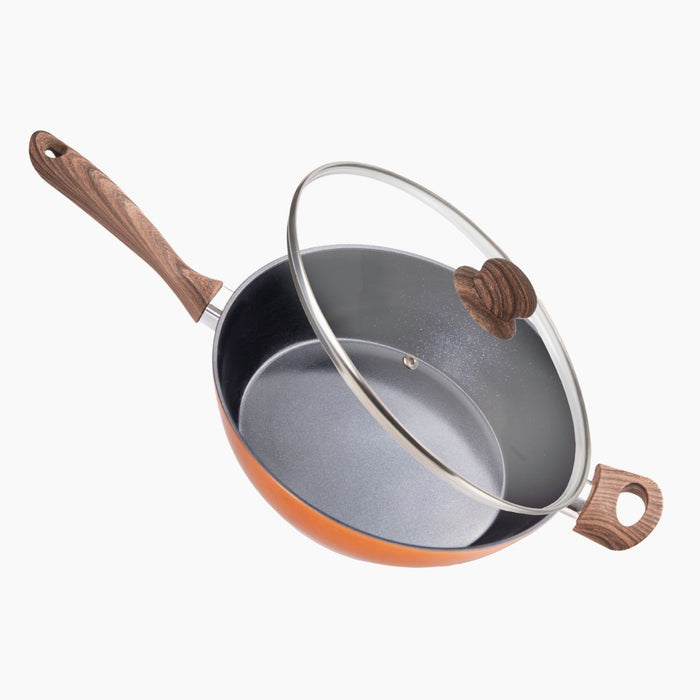 Copper-colored sauté pan with a glass lid for home cooking,