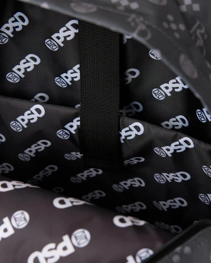 Black backpack material with repeated white logo print and black webbing strap detail.