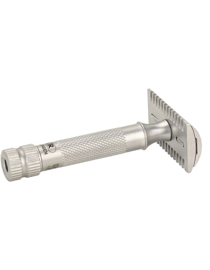 Merkur stainless steel safety razor with textured grip, shown with protective cap, packaging, and leather case for precision shaving.