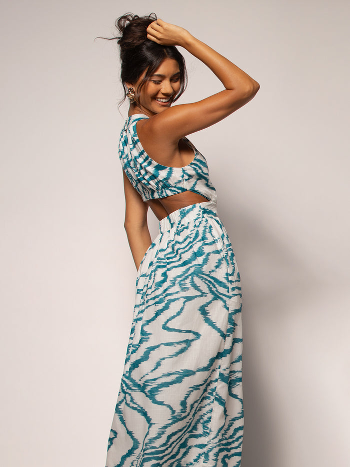 Blue and white cotton voile sleeveless dress, open back, plain background view.