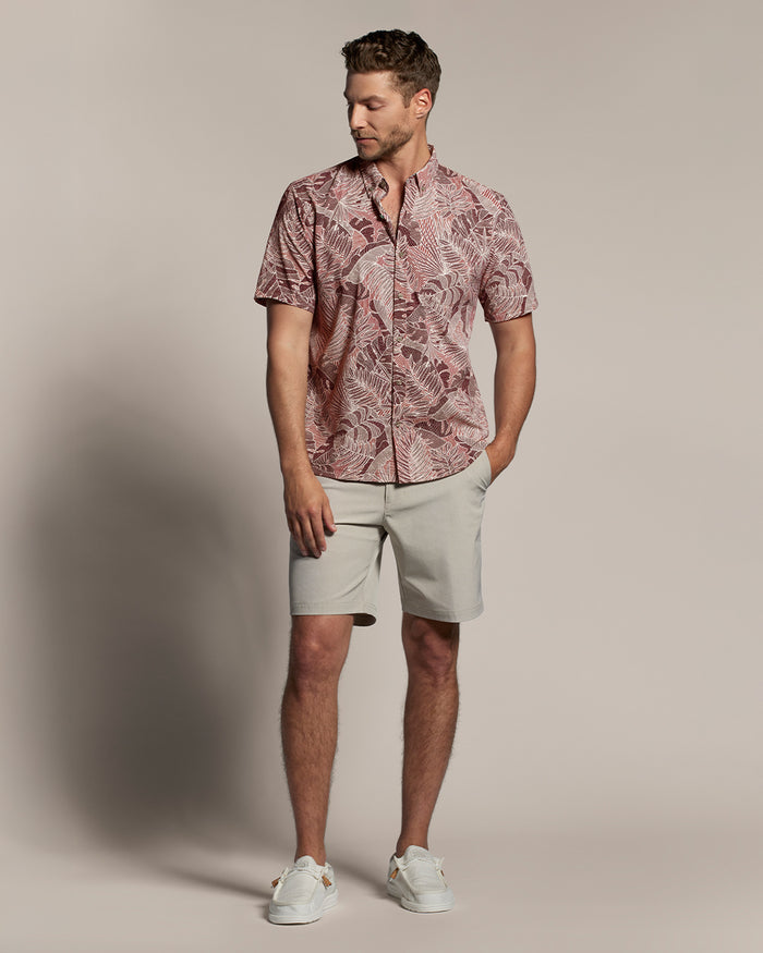 Maroon, pink, and white tropical-leaf print short-sleeve shirt, white sneakers, full front view.
