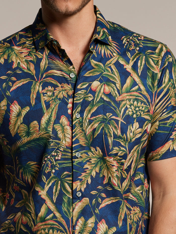 Green and brown tropical leaf-print cotton button-up- short sleeve shirt, front view.