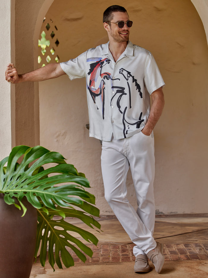 White abstract Year of the Horse print shirt, man smiling, front view